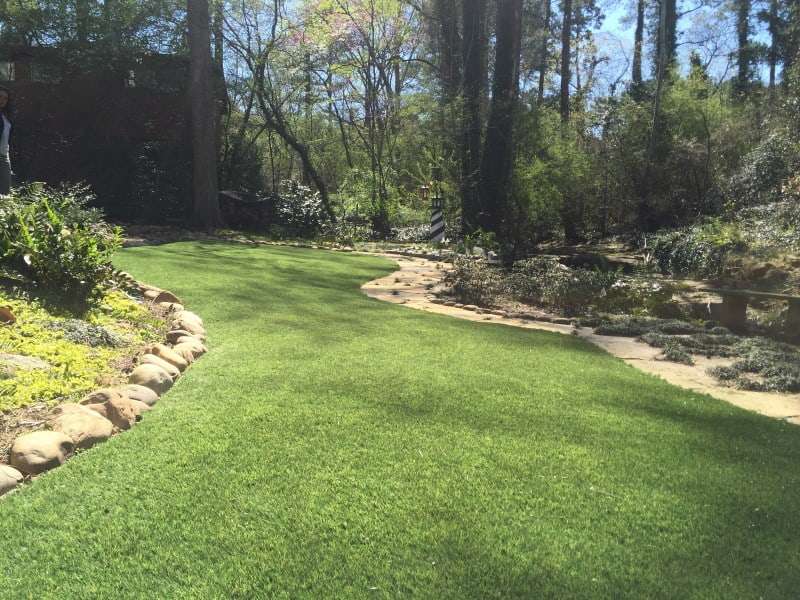 landscaped yard with fake grass