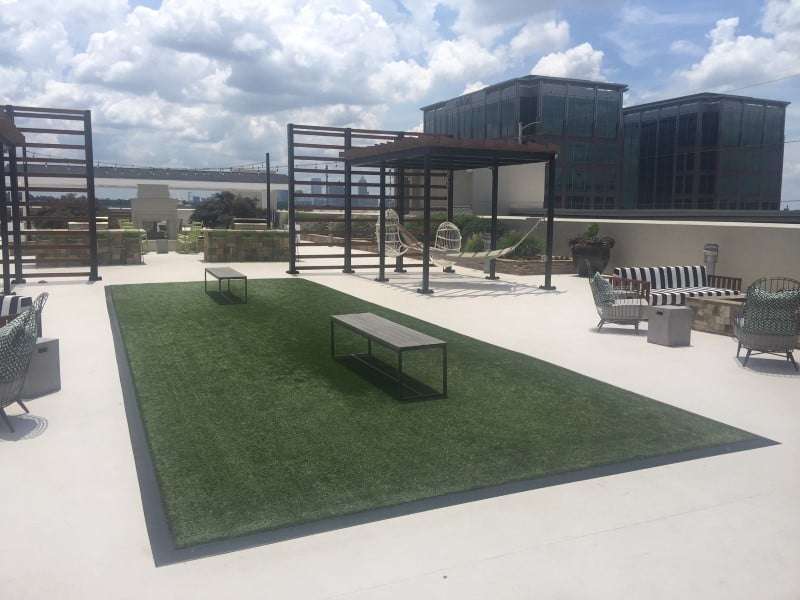 peninsula apartments rooftop with benches on artificial grass