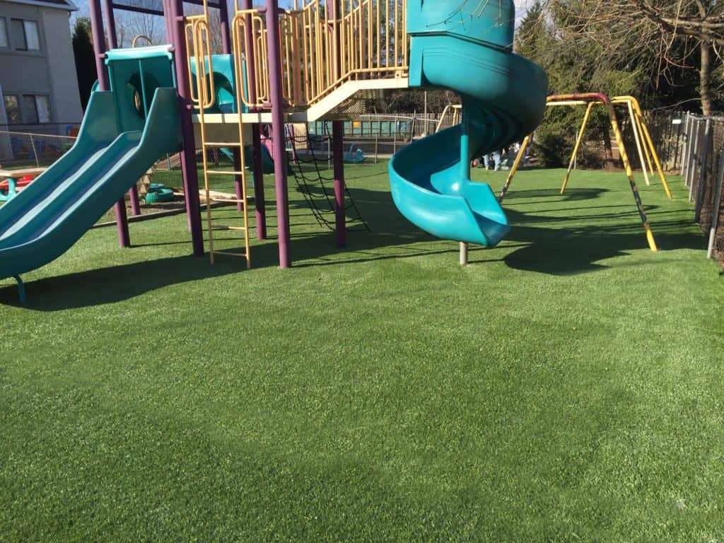 A daycare center with a playground on artificial turf in the mid-atlantic region
