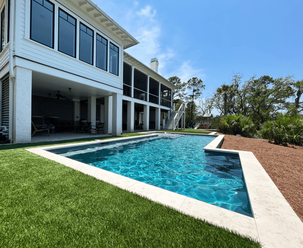 Artificial turf surrounding pool