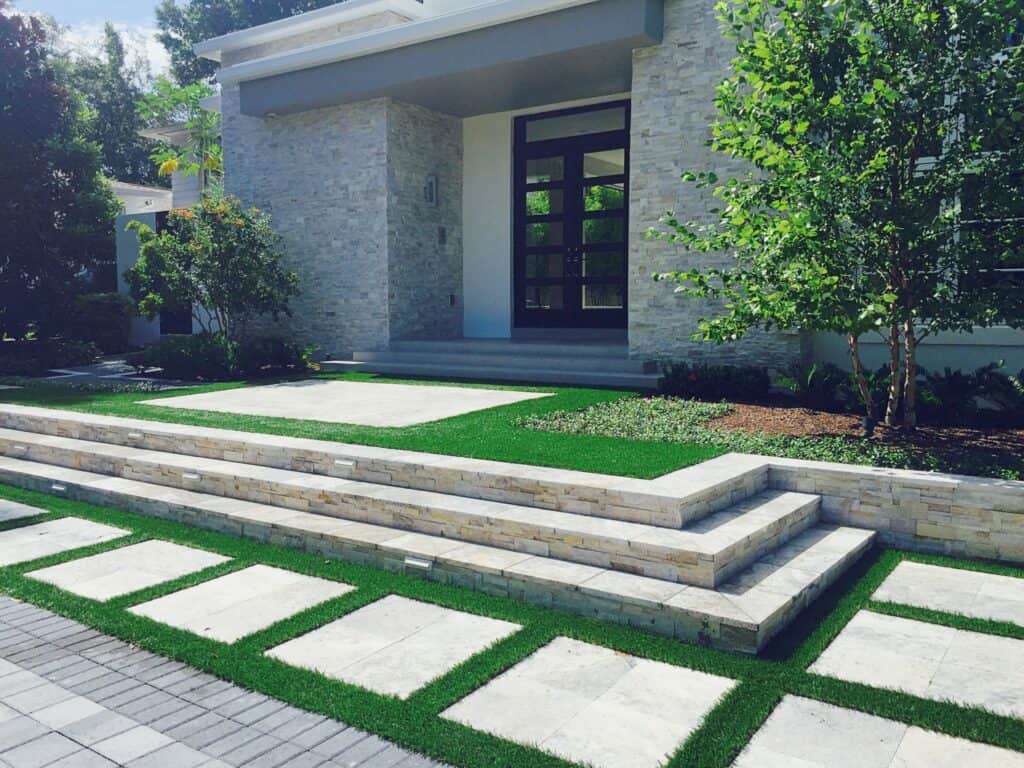 synthetic grass with pavers and sidewalk