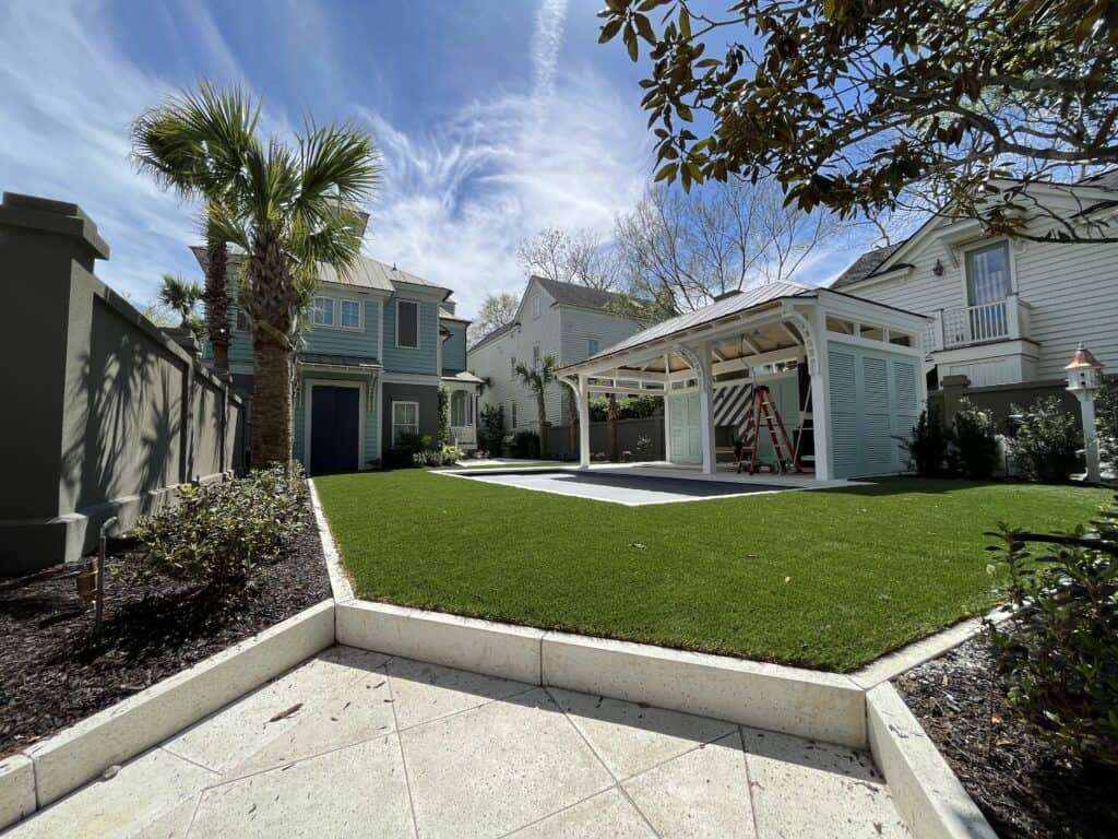 A house with an artificial turf lawn and a patio