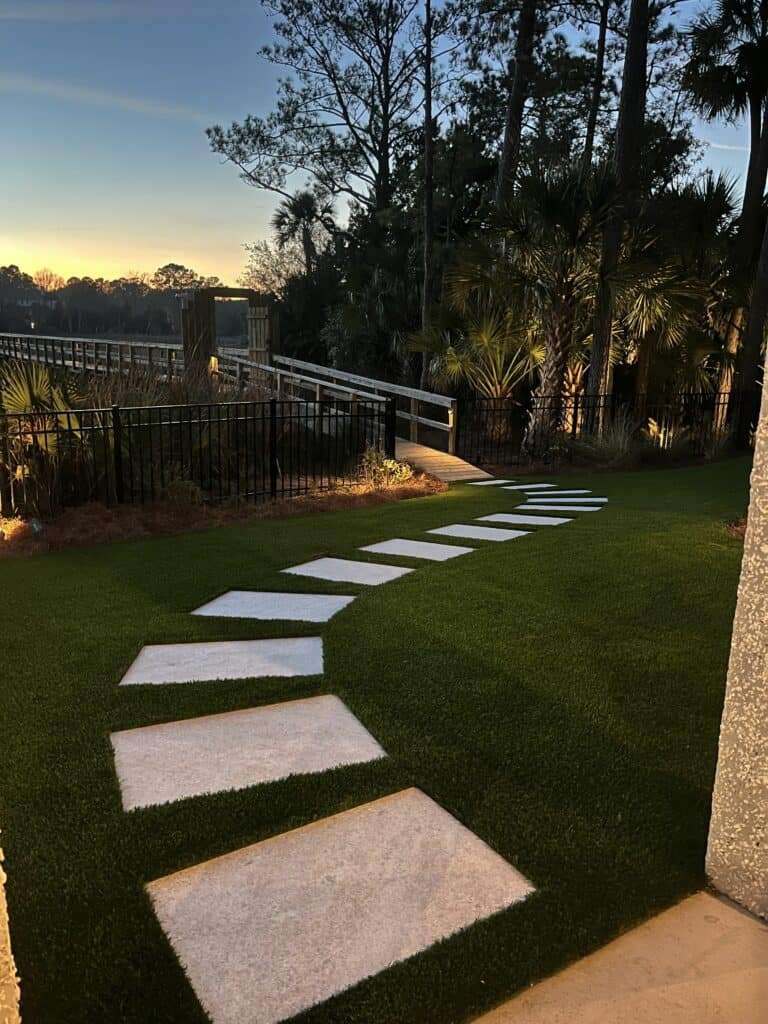 Artificial grass between pavers. 